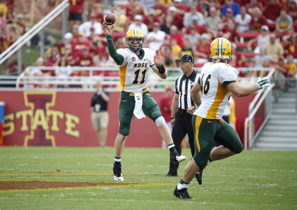 AMES, IA - AUGUST 30: Quarterback Carson Wentz #11 of the North Dakota State Bison passes to teammate fullback Andrew Bonnet #46 of the North Dakota State Bison in the second half of play against the Iowa State Cyclones at Jack Trice Stadium on August 30, 2014 in Ames, Iowa. North Dakota State defeated Iowa State 34-14. (Photo by David Purdy/Getty Images)